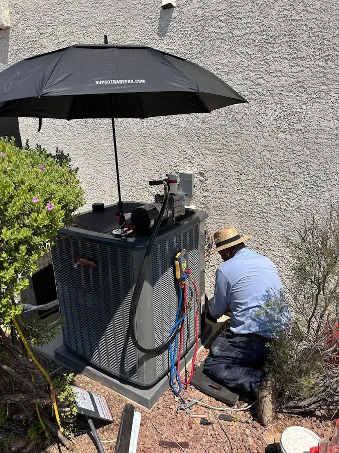 HVAC technician performing outdoor AC maintenance in Barnegat